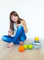 Jeune fille avec écouteurs et vert Pomme écoute la musique à Accueil photo