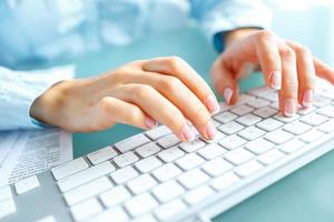 femme Bureau ouvrier dactylographie sur le clavier photo