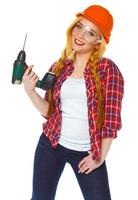 femelle construction ouvrier dans une casque avec une perforateur photo