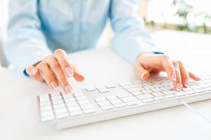 femme Bureau ouvrier dactylographie sur le clavier photo