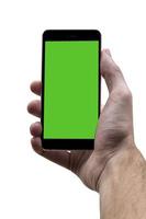 Masculin main en portant noir téléphone portable avec vert écran à isolé blanc Contexte. photo
