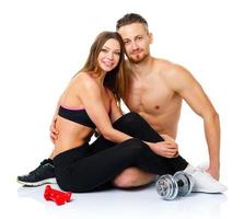 sport couple - homme et femme après aptitude exercice séance avec haltères sur le blanc photo