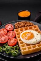 délicieux copieux petit déjeuner qui consiste de une frit œuf, Belge gaufre photo