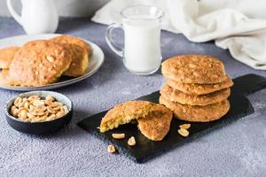 Frais cacahuète biscuits sur une ardoise et dans une assiette sur le tableau. fait maison des pâtisseries photo