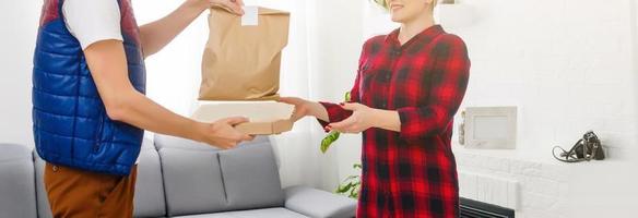 homme nourriture livraison en portant papier sac dans un appartement photo