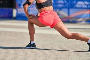 jeune femme s'échauffant avant de courir un marathon photo