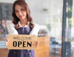 portrait de une femme, une café magasin affaires propriétaire souriant magnifiquement et ouverture une café magasin cette est sa posséder entreprise, petit affaires concept. photo