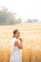 Jeune asiatique femmes dans blanc Robes dans le orge riz champ photo