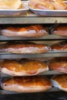 du pain fraîchement cuit se trouve sur les étagères, prêt à être vendu. photo