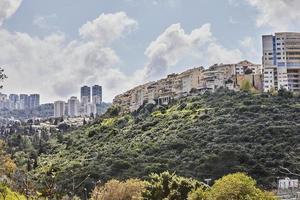 Nouveau et vieux bâtiments dans le ville de haifa dans le verdure sur le pente de le ravin, dans le printemps photo