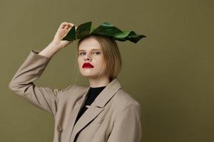 blond femme dans manteau rouge lèvres mode paume feuille studio modèle inchangé photo