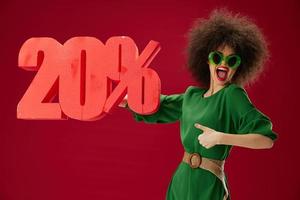 beauté mode femme vert robe afro coiffure foncé des lunettes vingt pour cent dans mains Couleur Contexte inchangé photo