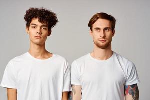 deux copains dans blanc t-shirts amusement émotions isolé Contexte photo