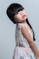 portrait asiatique mignonne peu fille pose pour prendre une photo dans studio sur blanc Contexte