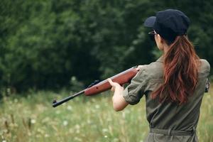 femme sur Extérieur en portant une arme est une chasse mode de vie noir casquette photo