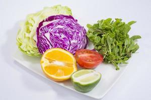 une assiette de des légumes et Frais citron vert et citron. photo