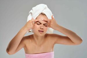 femme avec serviette sur tête nu épaules visage peau se soucier santé photo