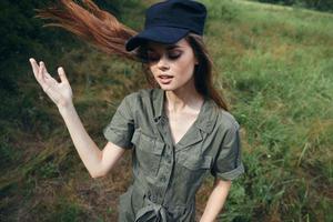 femme dans le forêt yeux fermé noir casquette vert costume des arbres photo