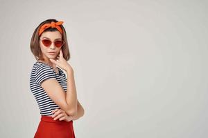 femme dans rayé T-shirt avec bandage sur sa tête portant des lunettes de soleil mode été photo