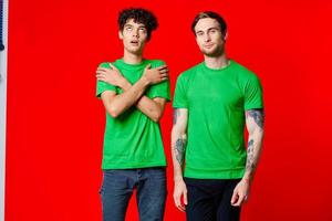 deux copains dans vert t-shirts la communication mode de vie rouge Contexte photo