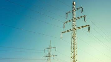 haute Tension électrique Puissance tours ou pylônes et câble lignes dans Allemagne, dans le bleu et vert le coucher du soleil ciel. concept de énergie la fourniture et énergie crise photo