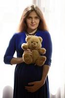 magnifique Enceinte femme avec une nounours ours. photo