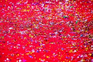 or ou argent Plastique lacets couverture sur le rouge tapis. rouge briller texture abstrait Contexte. photo