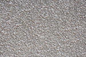 blanc strié stuc béton mur texture. extérieur bâtiment structure toile de fond. silice le sable ciment mur plâtre. photo