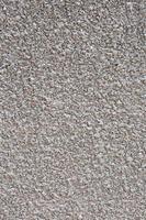 blanc strié stuc béton mur texture. extérieur bâtiment structure toile de fond. silice le sable ciment mur plâtre. photo