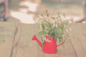 décoration avec petit fleurs dans une rouge canette d'eau photo