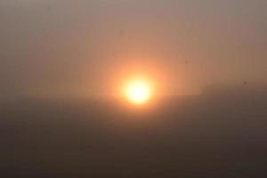 lever du soleil dans lourd brouillard photo