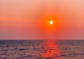 ciel coucher de soleil sur un paysage de plage, qu'il s'agisse des teintes chaudes d'un lever ou d'un coucher de soleil, reflet scintillant du soleil sur les nuages, le ciel et les nuages ont le pouvoir d'inspirer des sentiments d'émerveillement et d'émerveillement photo