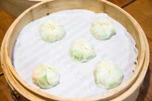 xiaolongbao, chinois à la vapeur chignon dans petit bambou panier. photo