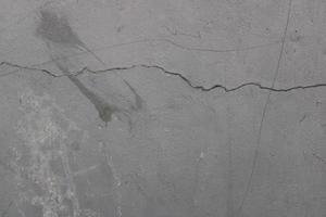 rugueux texture de un vieux gris fissuré mur sur le mur photo