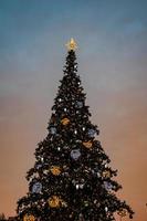 coloré Noël arbre chatoyant contre le Contexte de le soir pastel ciel photo