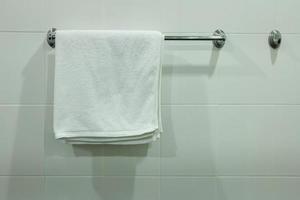 blanc une baignoire serviette pendaison sur le salle de bains photo