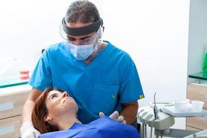 magnifique femme ayant dentaire traitement à dentiste bureau. photo