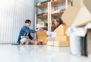 une Jeune couple court une petit affaires fabrication argile bijoux. elles ou ils soutien un un autre comme elles ou ils travail vers devenir plus grande affaires dans le avenir. photo