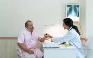 une femelle médecin examine le maladie et donne Conseil sur prise médicament. pour personnes âgées les patients recevoir traitement photo