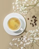 café composition avec tasse de Naturel café et café des haricots avec fleurs photo