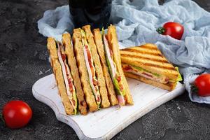 club sandwich avec jambon, tomate, vert et fromage. grillé panini photo