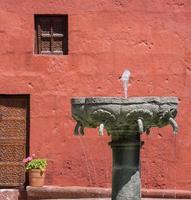 fontaine et façade rouge au pérou photo