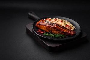 délicieux rouge Saumon poisson grillé avec sauce et sésame des graines avec riz et des légumes photo