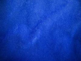 texture de tissu de velours bleu utilisée comme arrière-plan. fond de tissu bleu vide de matière textile douce et lisse. il y a de l'espace pour le texte. photo