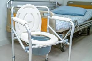 toilettes à chasse d'eau et chaise de douche dans la salle de bain pour personnes âgées. photo