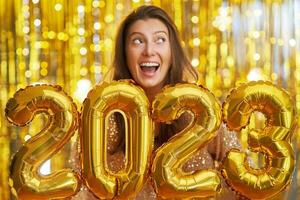 femmes à Nouveau année fête avec or des ballons photo