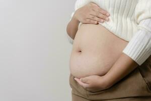 un obésité en utilisant mesure ruban à spectacle le réel taille. joufflu graisse femme en utilisant mesure ruban à ventre. réel Taille femme après donné naissance à bébé, réel peau avec les rides et cicatrices. photo