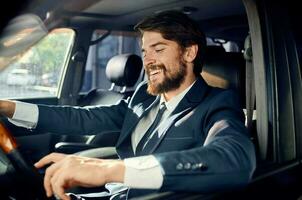 barbu homme dans une costume dans une voiture une voyage à travail Succès photo