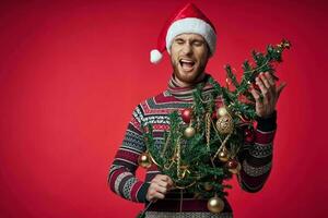 une homme dans une Père Noël chapeau Noël arbre décoration jouets rouge Contexte photo