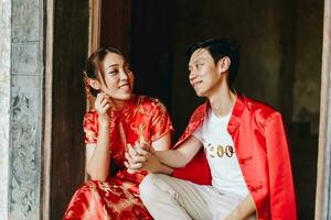 heureux jeune couple asiatique en robes traditionnelles chinoises photo